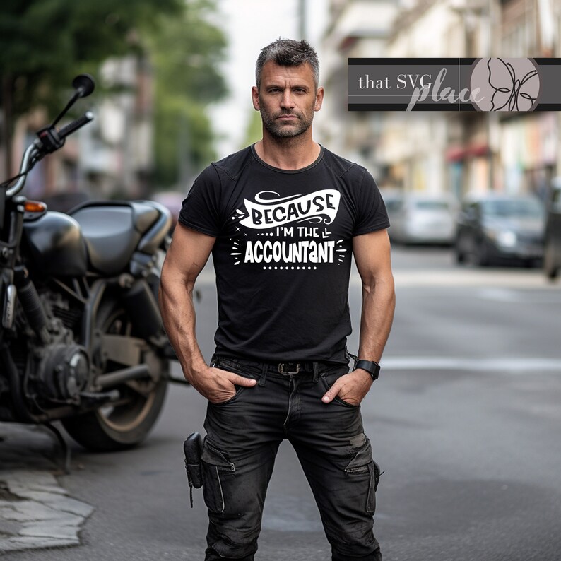 May include: A man wearing a black t-shirt with white text that reads "Because I'm the Accountant". He is standing in front of a motorcycle.