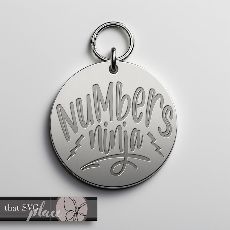 May include: Silver keychain with a round tag that says "Numbers ninja" in a stylized font.