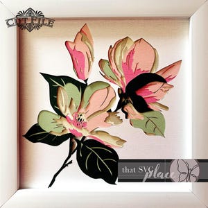 May include: A layered paper art piece featuring a magnolia flower in a white frame. The flower has pink and green petals, with black and green leaves. The artwork includes the text "CUT FILE" and "that SVG place".