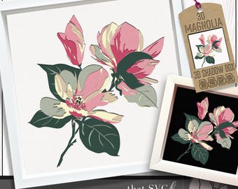 May include: A framed floral art print featuring a magnolia flower design in pink, green, and cream colors. The artwork is displayed in a white frame. A tag reads "3D Magnolia 3D Shadow Box".