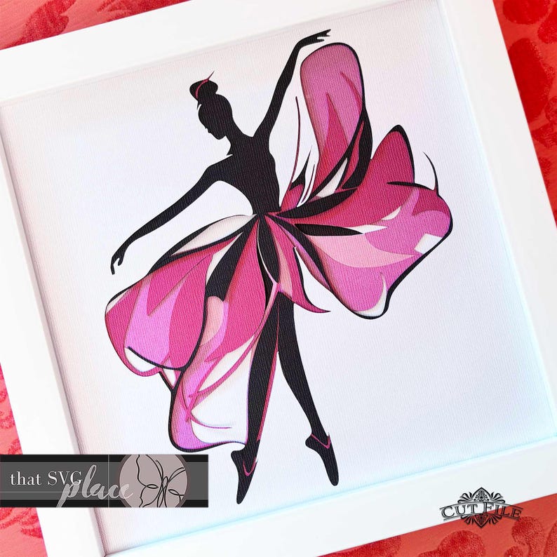 May include: A black silhouette of a ballerina with a pink and white paper flower skirt. The ballerina is framed in a white frame with the text "that SVG place" and "CUTFILE" in the bottom corners.