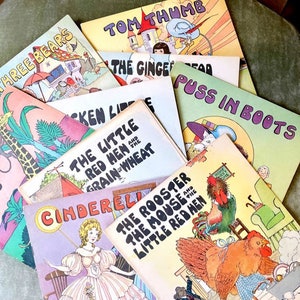 May include: A stack of vintage children's books with colorful covers featuring classic fairy tales like The Three Bears, Tom Thumb, Cinderella, and Puss in Boots.