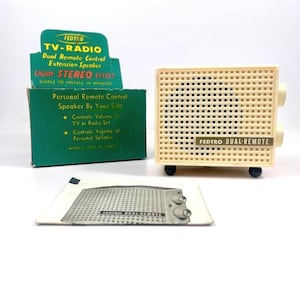 May include: A vintage white Fedtro TV-Radio dual remote control extension speaker with a grid pattern on the front. The box is green and white with the text "Fedtro TV-Radio Dual Remote Control Extension Speaker Enjoy Stereo Effect Simple to Install in Minutes Personal Remote Control Speaker By Your Side Controls Volume of TV or Radio Set Controls Volume of Personal Speaker With 22 Feet of Cable".