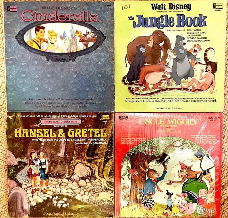 May include: Four vintage record albums featuring classic children's stories. The albums are in their original packaging and feature colourful illustrations of Cinderella, The Jungle Book, Hansel and Gretel, and Uncle Wiggily.