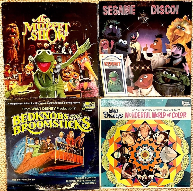 May include: Four vintage vinyl record albums featuring characters from Sesame Street, The Muppet Show, Bedknobs and Broomsticks, and Walt Disney's Wonderful World of Color. The albums are in a colourful, retro style.