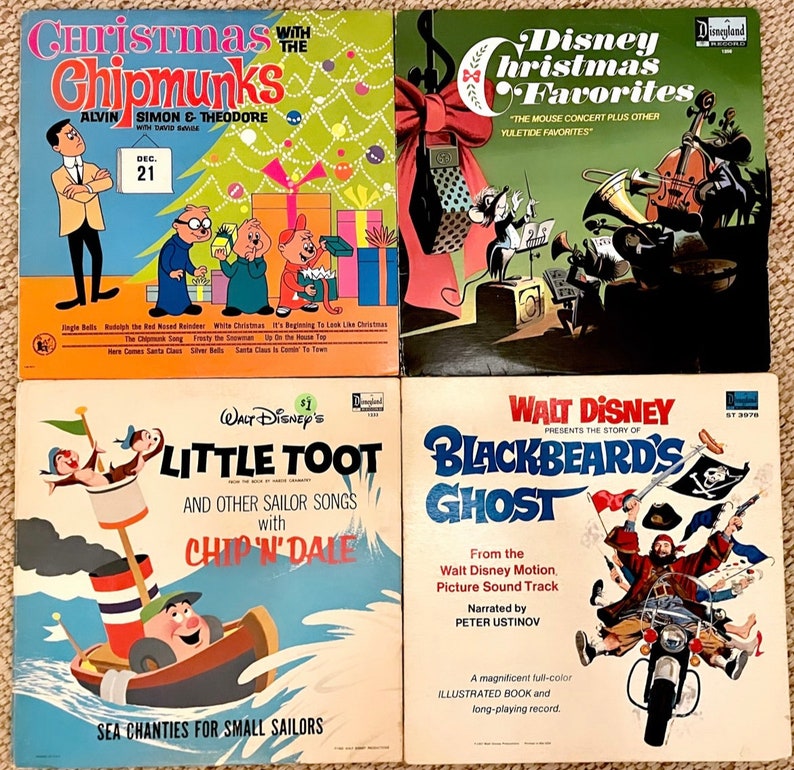 May include: Four vintage vinyl records featuring Christmas and children's themes. The top left record features the Chipmunks, the top right record features Disney Christmas Favourites, the bottom left record features Little Toot with Chip 'n Dale, and the bottom right record features Blackbeard's Ghost.
