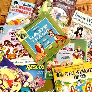 May include: A collection of vintage Disney storybook records, including "Winnie the Pooh," "Lady and the Tramp," and "Snow White." The covers feature colorful illustrations and text, with the records visible. The records are 33 1/3 RPM.