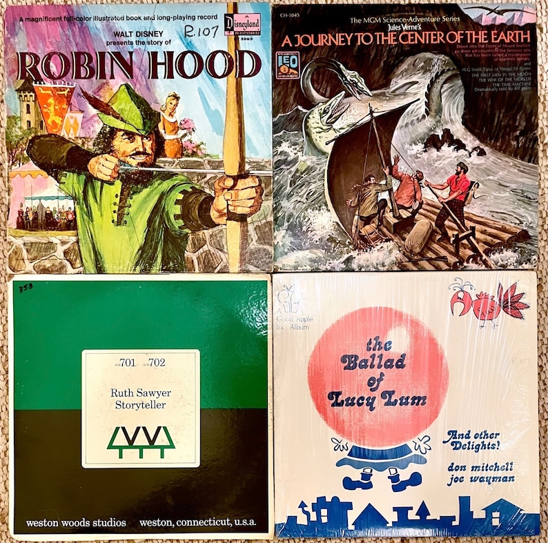 May include: Four vintage record albums with colourful covers. The top left album features Robin Hood, the top right album features a journey to the centre of the earth, the bottom left album features Ruth Sawyer Storyteller, and the bottom right album features the Ballad of Lucy Lum.