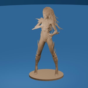 May include: A tan-colored figurine of a humanoid figure with long hair and sharp, claw-like appendages. The figure is standing on a circular base, with a blue background. The figure has a slender build and is in a dynamic pose.