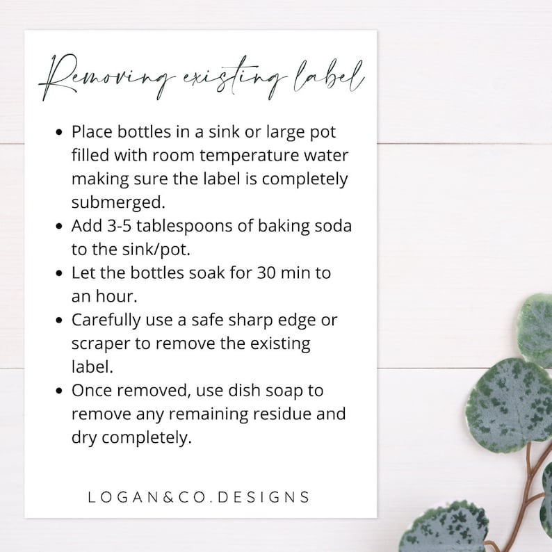 May include: A white card with black text outlining steps for removing existing labels from bottles. The steps include soaking the bottles in water and baking soda, then using a scraper to remove the label. The card also includes instructions for removing any remaining residue with dish soap. The text at the bottom of the card reads "LOGAN&CO. DESIGNS".