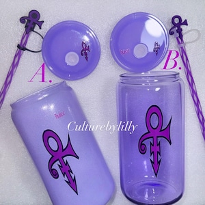 May include: Two purple tumblers with lids and straws. The tumblers feature a purple and pink Prince symbol. The lids are purple with a Prince symbol. The straws are purple and white striped.