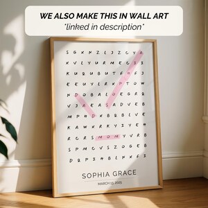 May include: A framed word search puzzle with the name "Sophia Grace" and the date "March 13, 2025" at the bottom. The puzzle has a pink check mark highlighting the word "MOMY". The text "WE ALSO MAKE THIS IN WALL ART *linked in description*" is at the top.