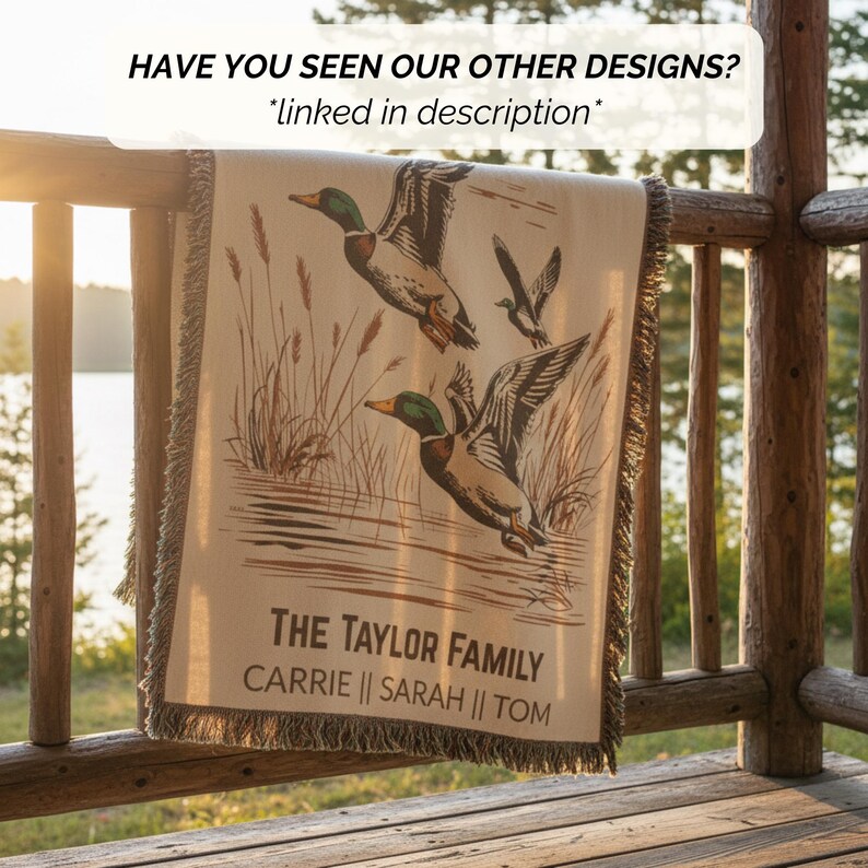 May include: A beige throw blanket with a duck illustration. The blanket has a fringed edge and the text "THE TAYLOR FAMILY" with names below. The image also includes the text "HAVE YOU SEEN OUR OTHER DESIGNS? *linked in description*".