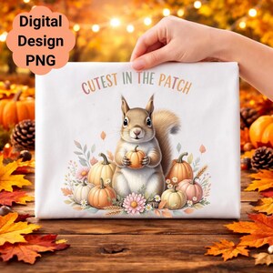 May include: A white rectangular design featuring a squirrel holding a pumpkin, surrounded by pumpkins and flowers. The text "Cutest in the Patch" is arched above the squirrel. The words "Digital Design PNG" are in a cloud-shaped box.