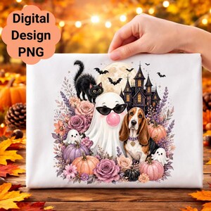May include: A white fabric surface featuring a graphic illustration of a ghost wearing sunglasses and blowing a pink bubble, a basset hound, a black cat, a haunted house, bats, pumpkins, and floral accents in shades of pink and purple.