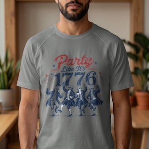 Men's grey t-shirt with "Party Like It's 1776" and dancing figures.