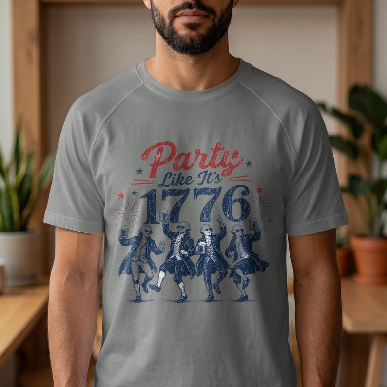Men's grey t-shirt with "Party Like It's 1776" and dancing figures.