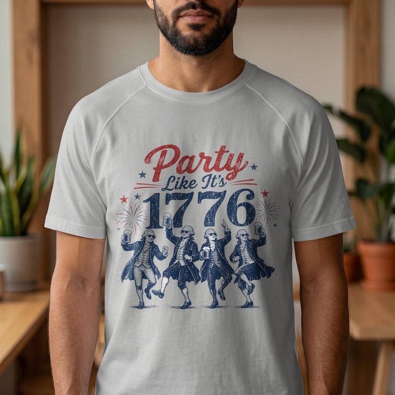White t-shirt with graphic "Party Like It's 1776" and dancing Founding Fathers.