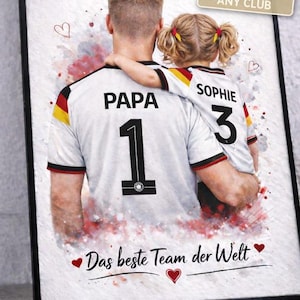 May include: Framed print featuring a father and child in matching soccer jerseys. The father's jersey has "PAPA" and the number "1", while the child's says "SOPHIE" and "3". The print includes the text "Das beste Team der Welt" and "PERSONALISED * ANY CLUB".