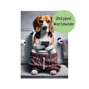 May include: A beagle dog sitting on a toilet, wearing red and black plaid pajama pants, and holding a smartphone. The dog is in a bathroom with a toilet, toilet paper, and a towel.