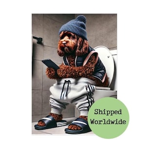 May include: A brown dog wearing a blue beanie and grey sweatpants sits on a white toilet seat and holds a black smartphone. The dog is wearing black and white sliders. The text "Shipped Worldwide" is on a green circle.