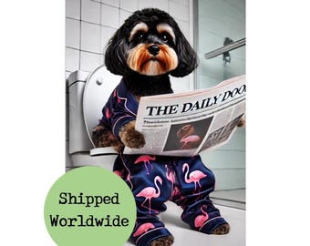 May include: A black and brown dog wearing blue pajamas with pink flamingos printed on them. The dog is sitting on a toilet and reading a newspaper titled "The Daily Doo".