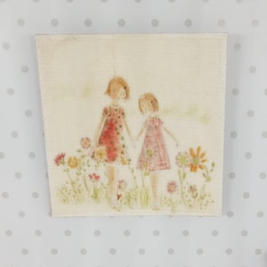 Może przedstawiać: Kwadratowe, teksturowane dzieło sztuki przedstawiające akwarelową ilustrację dwóch młodych dziewcząt trzymających się za ręce na polu kwiatów. Dziewczyny mają na sobie sukienki, jedną czerwoną i jedną różową, z miękką paletą pastelowych kolorów.