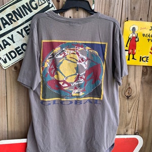 May include: Grey t-shirt with a graphic of a colourful globe and the word "GLOBAL" printed on the back.