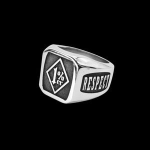 Op de afbeelding: Een zilverkleurige zegelring met een vierkant voorvlak en een ruitvormige gravure met de tekst 1%er. De zijkant van de ringband toont het woord RESPECT in dikke, donkere letters op een verzonken, getextureerde achtergrond.