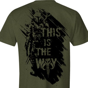 May include: A green t-shirt with a black graphic print of a Mandalorian character with the text "This is the Way".