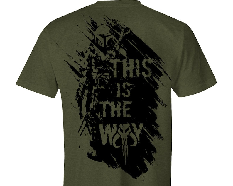 May include: A green t-shirt with a black graphic print of a Mandalorian character with the text "This is the Way".