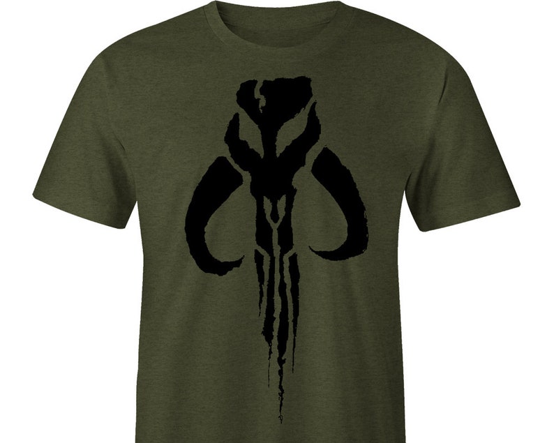 May include: A green t-shirt with a black Mandalorian symbol printed on the front.