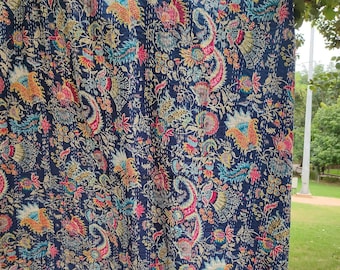 May include: A dark blue kantha quilt with a floral pattern in shades of pink, yellow, and green. The quilt is made of cotton and is hand-stitched.