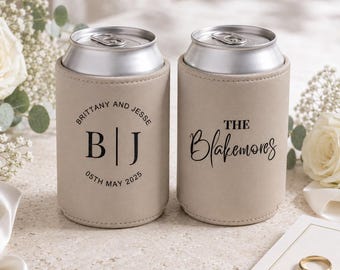 May include: Two beige neoprene can coolers with silver aluminum tops. The left cooler features the text "BRITTANY AND JESSE", "B | J", and "05TH MAY 2025". The right cooler features the text "THE Blakemores" in a mix of serif and script fonts.
