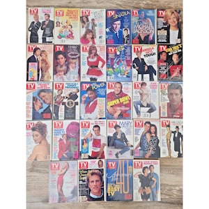 May include: A collection of vintage TV Guide magazines, featuring various celebrities and show titles. The covers showcase actors, singers, and TV personalities from the 1980s and 1990s, with bold text and colorful designs. The magazines are arranged on a light-colored surface.