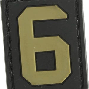 May include: A black and tan velcro patch with the number "6" in a large, bold font.