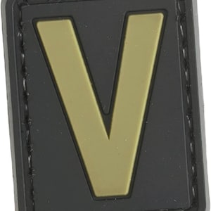 May include: Black and gold embroidered patch with the letter "V" in a gold color.