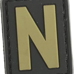 May include: Black and tan fabric patch with the letter "N" in a large, bold font.