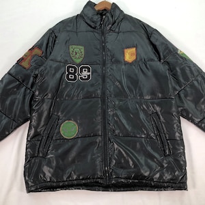 May include: A black puffer jacket with multiple colourful patches, including a large "89" patch on the front.