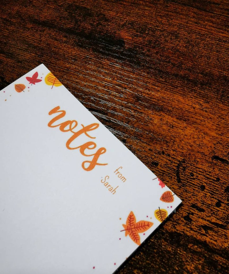 May include: White notepad with a fall theme border. The notepad has the word "notes" written in orange cursive and the text "from Sarah" below it.