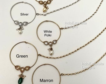 May include: Four nose rings with chains, each with a different colored stone: golden with a white stone, silver with a white stone, green with a green stone, and maroon with a red stone. The text "IndoExquisite Designs" appears three times on the image.