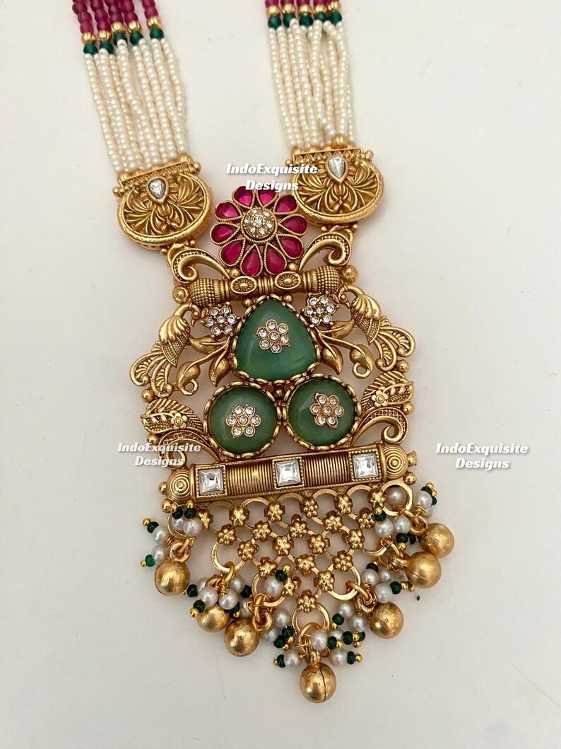 Sukkhi Premium Rakhi Combo Set For Brother - 2 Gold Plated Kundan & Pearl Rakhis With Meenakari, Roli Chawal & Greeting Card (CBRAK106943)