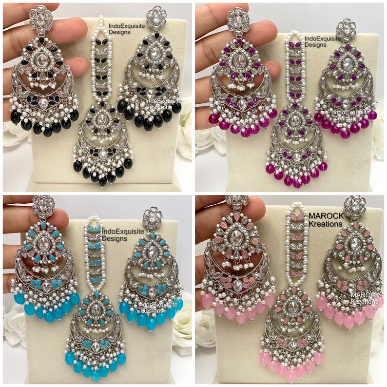 May include: Four sets of silver earrings and maang tikka, a traditional Indian headpiece. The earrings feature a crescent moon design with colorful stones and pearls. The maang tikkas are a chain with a pendant. The colors are black, pink, blue, and turquoise.