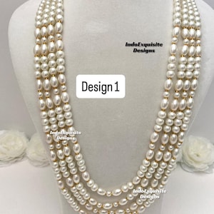 May include: A multi-strand pearl necklace with a mix of round and oval pearls. The necklace has gold-colored accents and is displayed on a white mannequin. The text "Design 1" is visible.