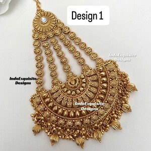 May include: Gold-toned headpiece with intricate floral and beaded details. The design features a central circular element with a clear stone, cascading strands, and a decorative lower section. The text "Design 1" is visible.