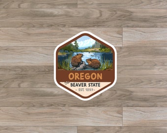 May include: A brown and white sticker with a hexagonal shape. The sticker features a cartoon illustration of two beavers in a river with a mountain range in the background. The text "Oregon, The Beaver State, Est. 1859" is printed on the sticker.