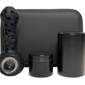 May include: A black silicone smoking pipe with a honeycomb design, a black grinder, a black storage container, and a black carrying case.