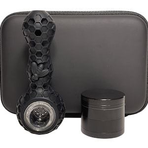 May include: A black silicone honeycomb pipe with a bee design, a black grinder, and a black carrying case.