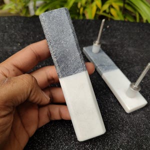 May include: Two black and white marble cabinet door pulls with silver hardware.