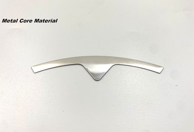 K&ouml;nnte beinhalten: Ein silberfarbenes Metallkernmaterial in Form eines gebogenen Bogens mit einer spitzen Mitte.